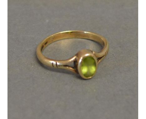 A 9ct. Yellow Gold Dress Ring set with oval peridot 