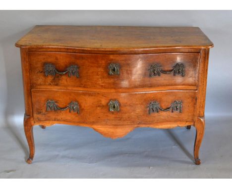 An 18th Century French Fruit Wood Serpentine Commode with two deep drawers and brass handles and escutcheons, raised upon cab