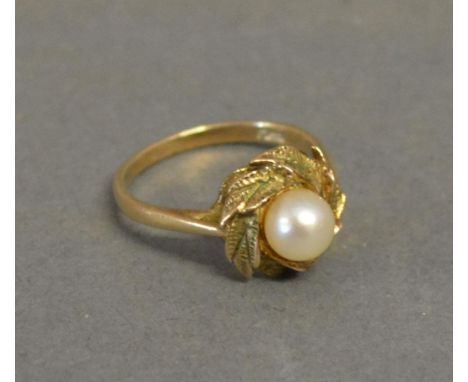 A 9ct. Yellow Gold Dress Ring set with single stone within a wreath setting 