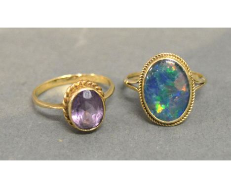 A 9ct. Gold Amethyst Set Ring together with a similar 9ct. gold opal set ring 