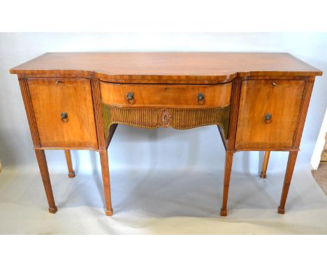 A Mahogany Semi Bow Fronted Sideboard with a frieze drawer flanked by cupboard doors with lion mask ring handles, raised upon