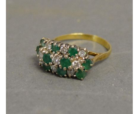 An 18ct. Yellow Gold Emerald and Diamond Ring with three bands of diamonds and emeralds within a pierced setting 