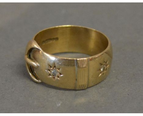 A 9ct. Yellow Gold Ring in the form of a buckle set with two diamonds, 7.5 gms. 