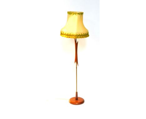 A Vintage 1950's teak brass rod standard lamp, raised on a circular base, with shade, 142cm H. 