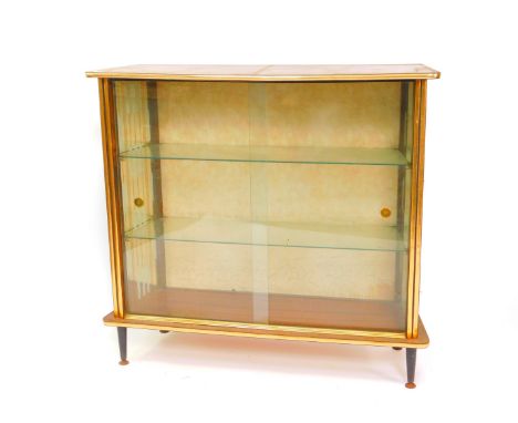 A vintage 1950's teak display cabinet, of trapezium form, with two glazed doors opening to reveal two glass shelves and decor