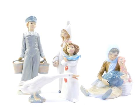 Four Lladro porcelain figures, comprising a boy carrying two water buckets, girl in nightgown, seated girl with a basket of a