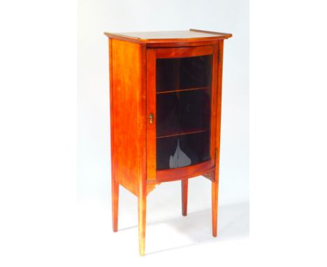 An Edwardian mahogany bow fronted display cabinet, by A Wilson, Peck &amp; Company Ltd., Sheffield, the glazed door opening t