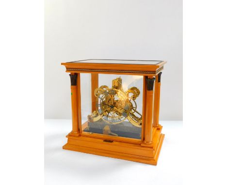 A contemporary brass skeleton clock, chapter ring bearing Roman numerals, single fusee clockwork movement, the case of scroll