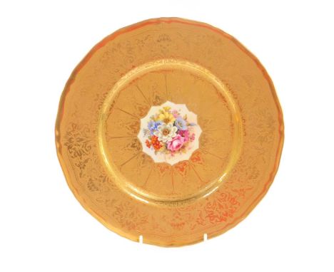 A Royal Worcester porcelain cabinet plate, circa 1958, painted by Freeman, with flowers, within a tooled gilt ground and bord