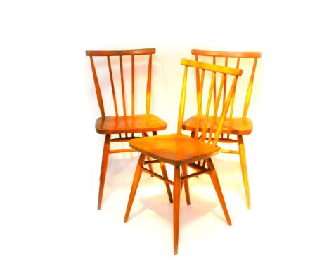 A set of three Ercol elm and beech stick back kitchen chairs, model 391.