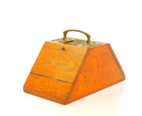 A Victorian oak cigarettes and cigars box, of trapezium form, with brass carrying handle, matches trough and two strikers, fl