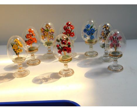 Eight House of Faberge cut glass and enamel floral bouquets, each contained within an egg on an integral stand, with certific