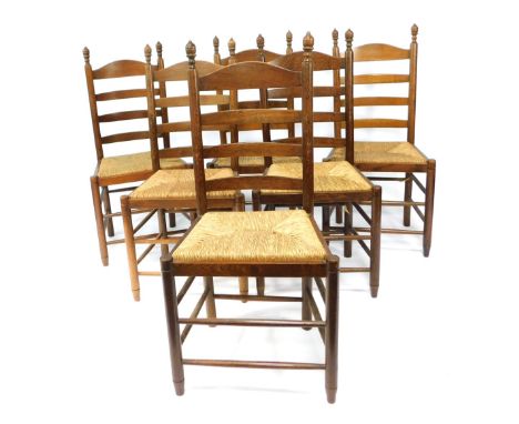 A set of six oak rush seated ladder back chairs.