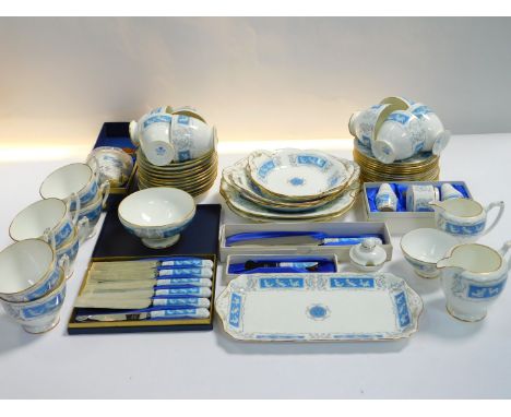 A Coalport porcelain tea service decorated in the Revelry pattern, comprising two graduated cream jugs, two sugar bowls, pres