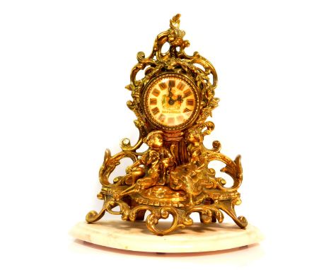 A French brass mantel clock by Rocha and Meirelles, Paris, the circular enamel dial bearing coat of arms and Roman numerals, 