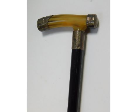 A George V ebony walking stick, with horn handle, with silver caps and ferrule, foliate engraved with shield reserve, London 