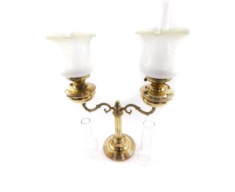 A Victorian style brass twin branch oil lamp candelabra, with glass chimneys and etched frosted clear to green glass shades, 
