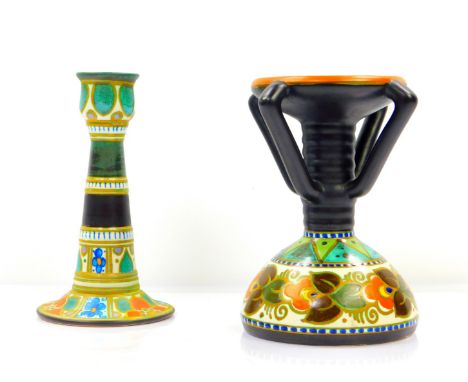 A Gouda Pottery candlestick, decorated in the Danier pattern, of four handled form, raised on a fluted stem and conical base,