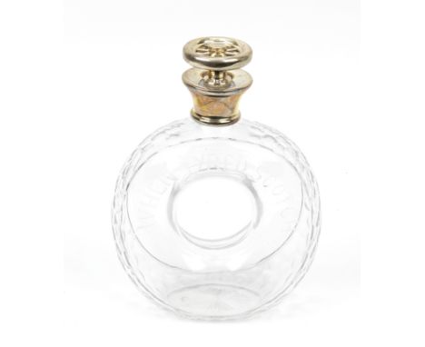A novelty 'When Tyred, Scotch' cut glass whisky decanter, pre-War,in the form of an early motorcar tyre, with facet-cut tread