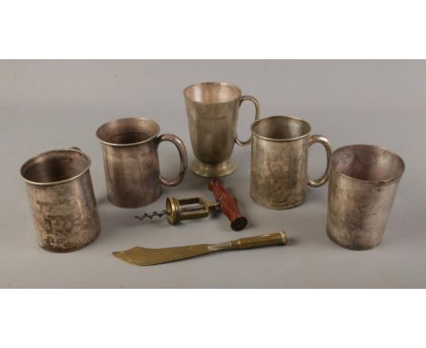 A selection of pub measuring tankards together with a trench art souvenir letter opener and corkscrew.  