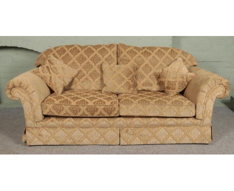 A three piece sofa suite with beige floral upholstery. Comprising of three seat sofa, two seat sofa and armchair.  