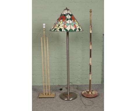 Three standard lamps and lamp bases. To include Tiffany style and onyx base examples.  Some cracks and pieces missing to Tiff