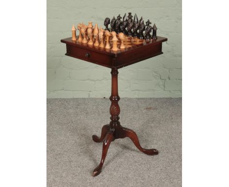 A mahogany chess table, on turned central pillar supported by carved tripod base. With double sided drawer and two sets of ga