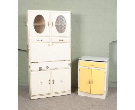 A painted utility cabinet with another smaller cabinet with enamel top.  