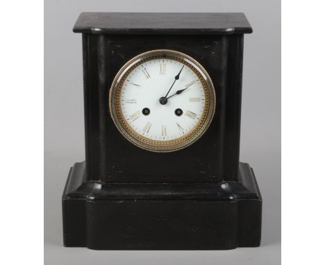 A black slate mantel clock featuring roman numeral face. With pendulum, no key.  Not working.