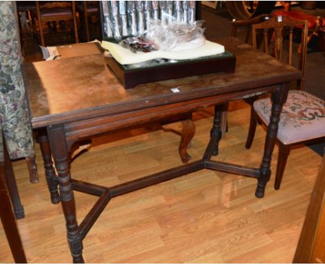 A Victorian rosewood fold over card table, with green baise lined interior, raised on turned supports with under stretchers, 