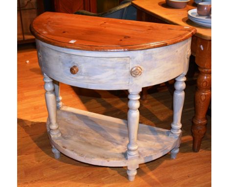 A painted pine demi-lune console table, with single drawer above undertier, raised on turned supports, 78cm high x 91cm wide