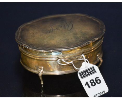 A George V silver trinket box, Birmingham 1917 by Edward Souter Barnsley, of oval form with moulded scalloped lids, on cabrio