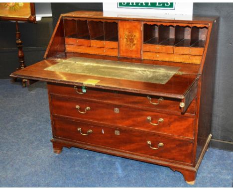 A 19th century mahogany writing bureau, with fall front writing flap enclosing fitted drawers and pigeon holes, above four gr