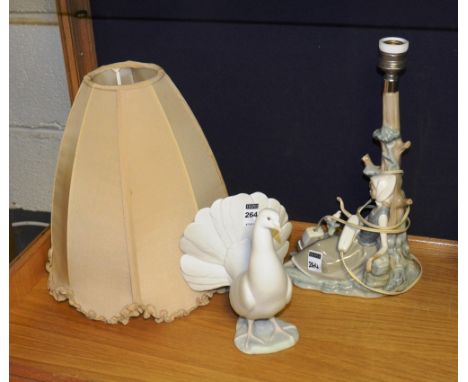 A Lladro figure of a dove, 21cm high, together with a Lladro table lamp in the form of a girl with dove at tree, with shade, 