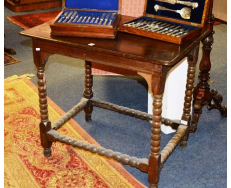 An antique country style side table, the top possibly yewwood, raised on bobbin twist supports, 74cm high x 83cm wide