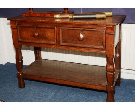 A Continental oak buffet, the rectangular top over two beaded short drawers, raised on baluster legs, united by shelf, 134cm 