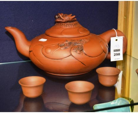A Japanese Teracotta saki teapot, with grotesque mask finial and relief decoration, rein marks to base, 35cm diameter, with f
