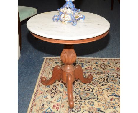 A Victorian style hardwood circular supper table, with white marble top above reeded column, ending in scroll tripod supports
