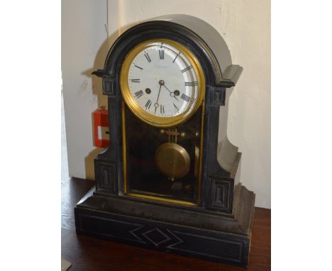 A late Victorian black slate mantle clock by Hamilton & Inches of Edinburgh, the white enamel dial with black Roman numerals,