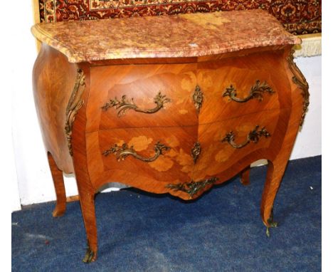 A Louis XVI style bombe commode chest, with mottled marble top above two drawers, decorated with gilt metal handles, applique