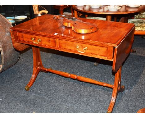 A modern yewwood sofa table, with two drawers and opposing dummy drawers, raised on lyre supports, 73cm high x 152cm wide