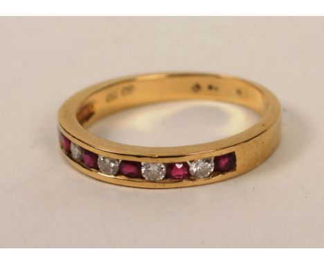 An 18ct gold ruby and diamond half eternity ring, with five brilliant cut diamonds, approximately 0.15ct in total, interspers