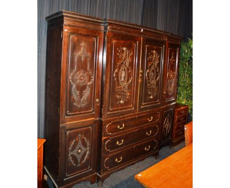 A large mahogany breakfront wardrobe, in the Chippendale manner, stamped to top drawer 'Phillips, Bristol', with dentil mould