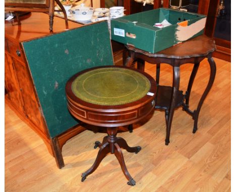 A reproduction drum style occasional table, with green leather inset to top, above two drawers and column support, 64cm high 
