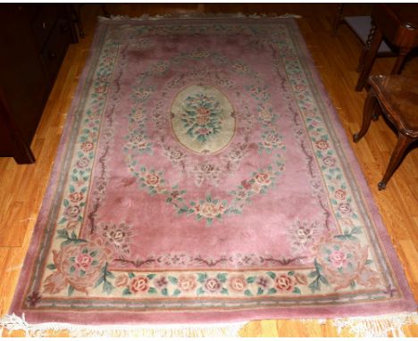 A Chinese carpet, the floral medallion over peach ground with floral decoration and border, 275 x 183cm