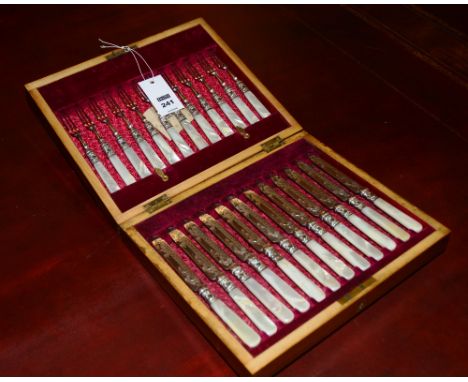 A set of 12 plated fruit knives and forks, with mother of pearl handles, the blades with etched foliate decoration, in fitted