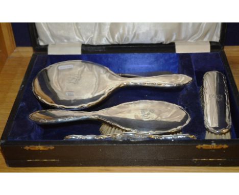 A George V cased Birmingham silver brush set, dated 1919 by ES Barnsley & Co, comprising of mirror, two brushes, comb and add