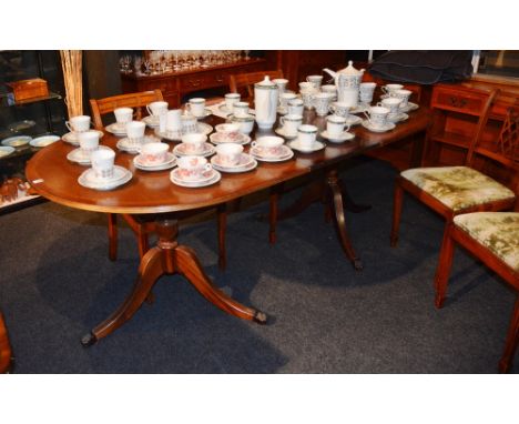 A reproduction D-end dining table, raised on tripod pedestal bases, with spare leaf, 76cm high x 202cm long x 99cm wide