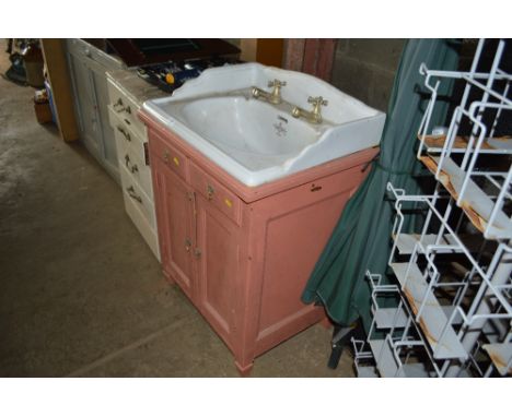 A ceramic sink raised on covered base