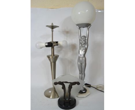 Art Deco style silvered table lamp in the form of a female nude holding aloft a globe, together with two other Art Deco style